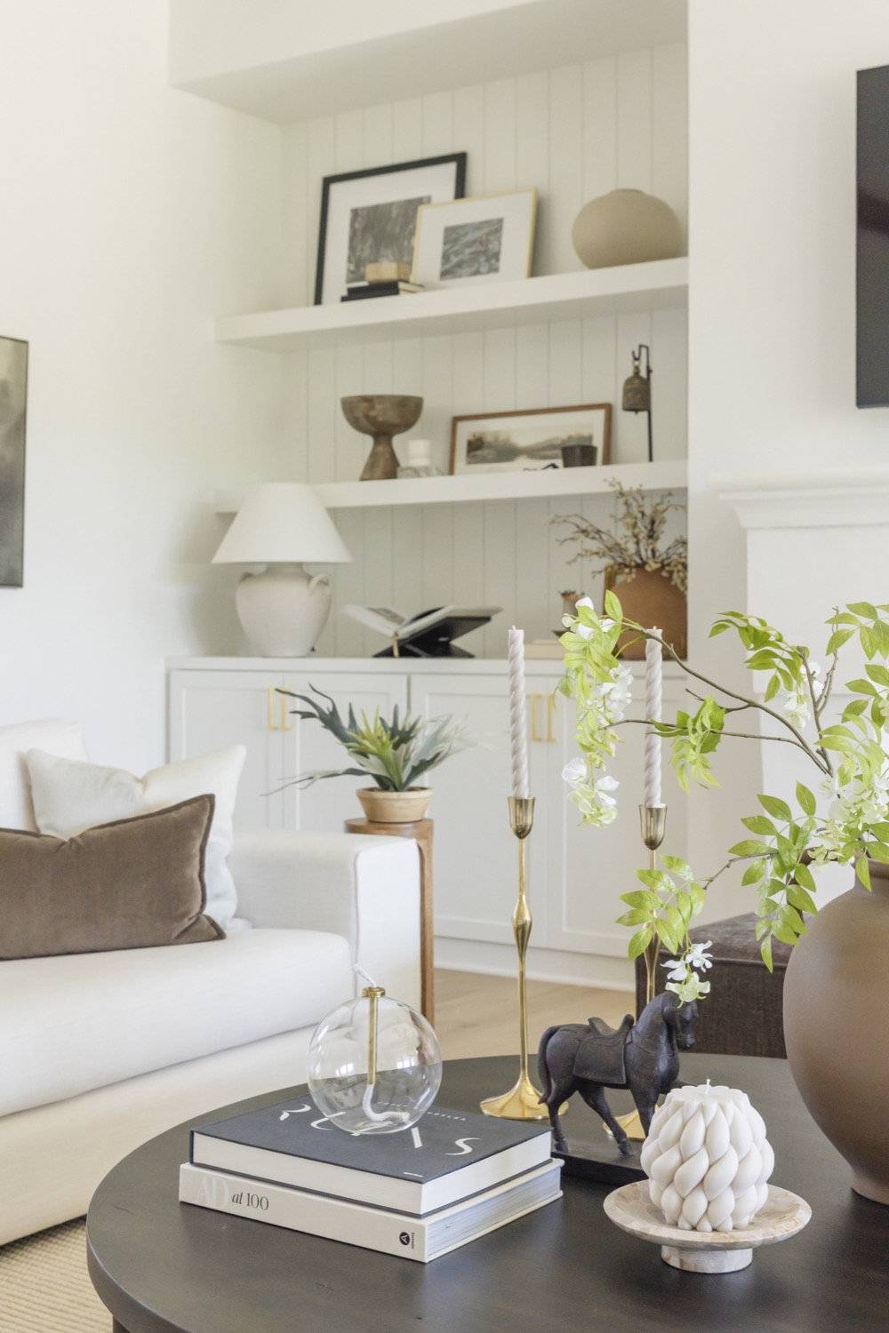 Warm neutral living room with built-in shelves and natural wood accents